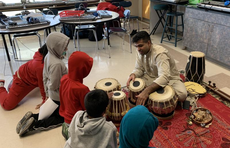 Devesh Chandra demonstrates drumming techniques to students