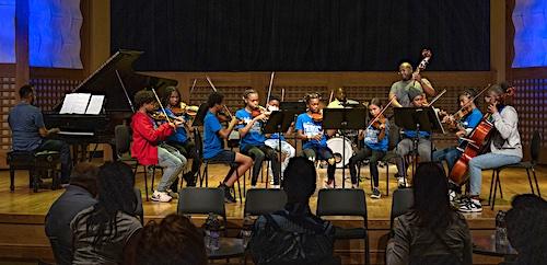 Student orchestra performing on stage