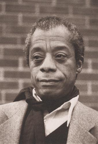 Black and white photo of Black man with a jacket and black scarf