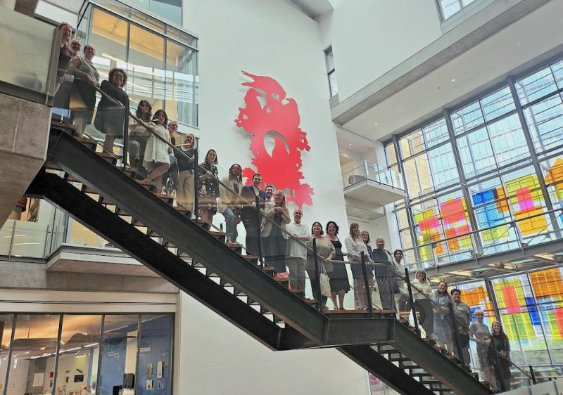 A group of people posing on a long stairway.