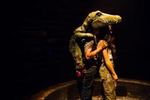 A man in an alligator suit hugs a woman
