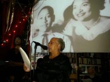 A woman reading at a podium