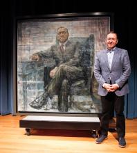 Actor Kevin Spacey stands next to a portrait of himself as TV character Frank Underwood