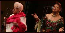 two older women in fancy gowns singing