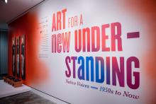 the entrance to the exhibit with the exhibit title painted ont he wall