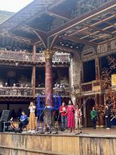 A young Indian woman recites on the Globe stage