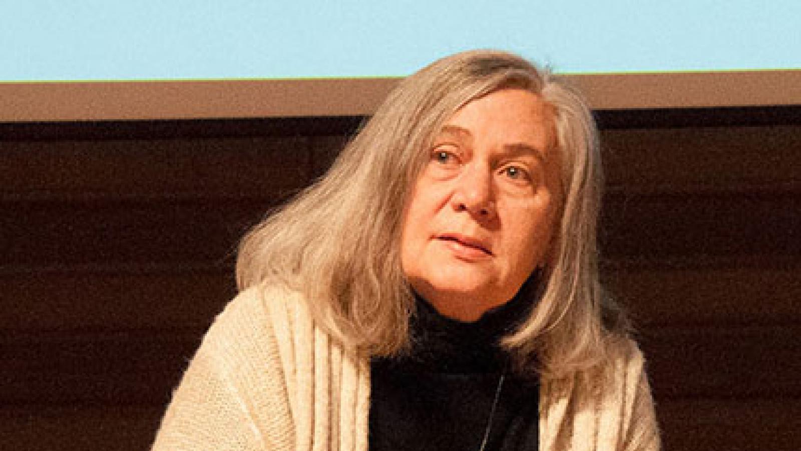 Marilynne Robinson sitting on a chair and talking to an audience.
