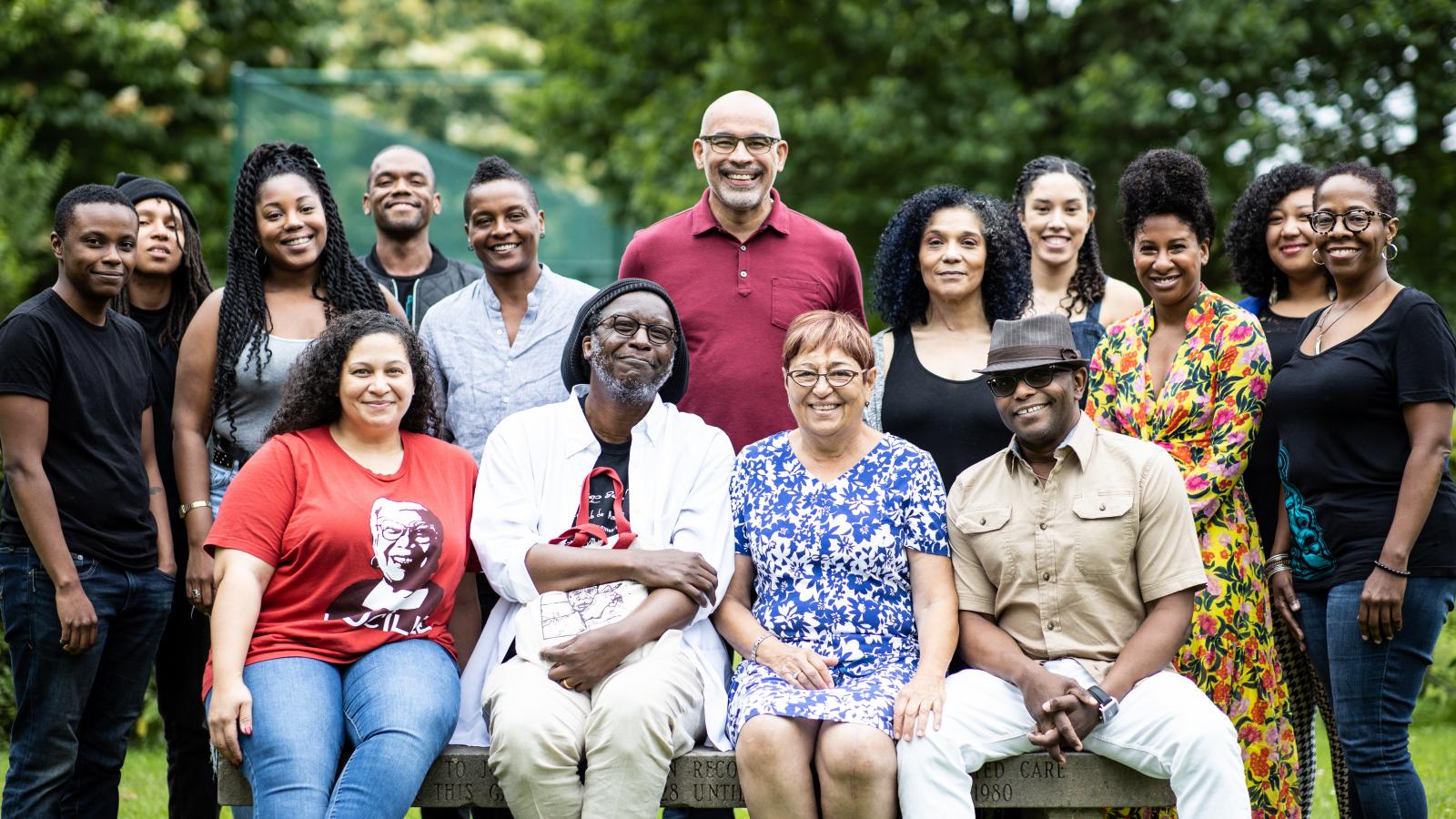 Group of Black writers posing for photo outdoors. 