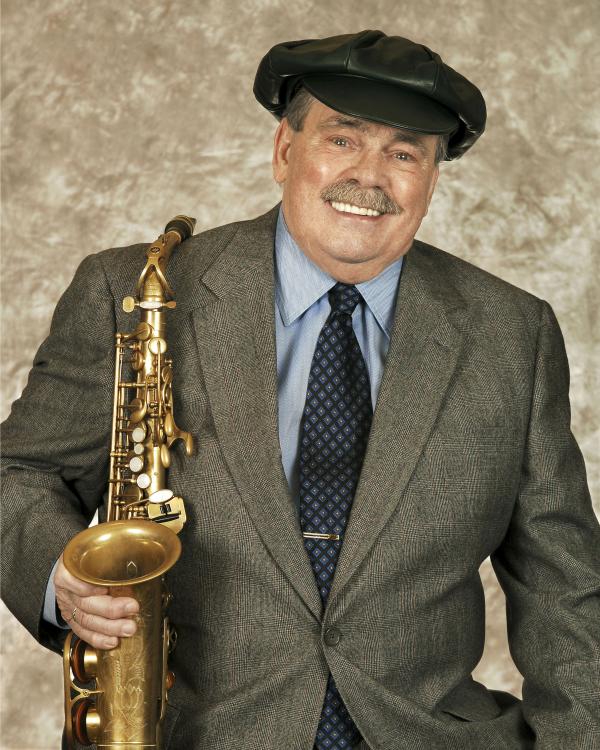Portrait of Phil Woods holding saxophone