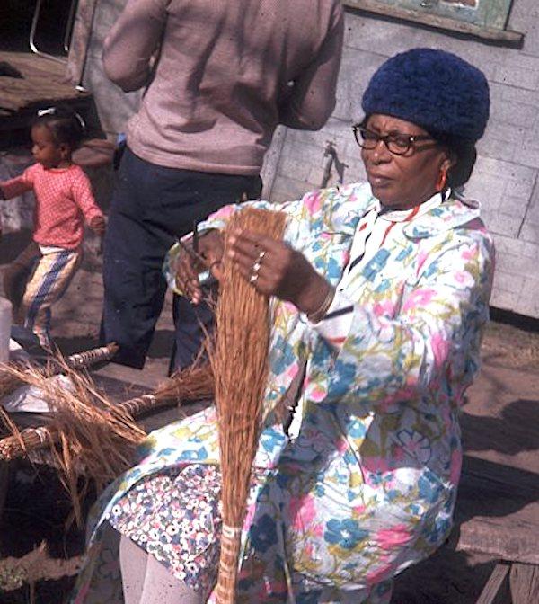 A woman making a straw broom.