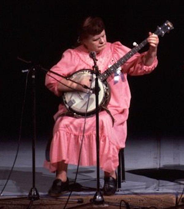 A woman playing a banjo.