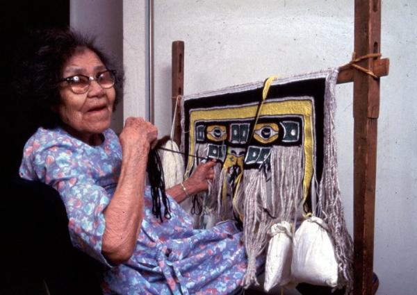 A woman at a loom.